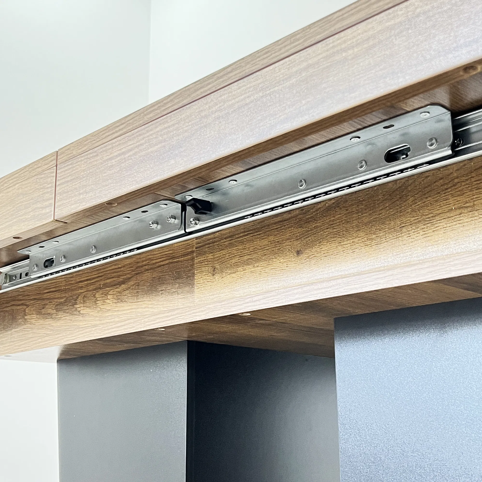Extendable Brown Dining Table for 6–10, 79" — close-up of the metal extension mechanism