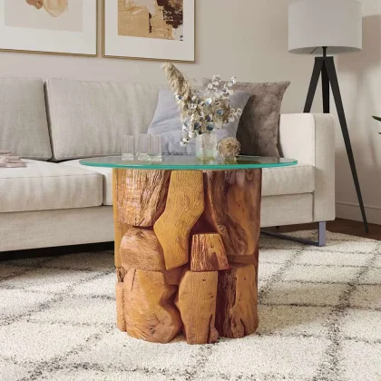 Round Teak Driftwood Coffee Table with Glass Top, 24" — styled in a bright living room beside a sofa
